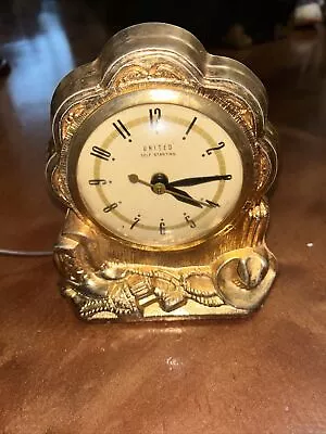 VINTAGE CLOCK UNITED-BRASS-ELECTRIC WORKING-COWBOY MOTIF-6.5 TALLx6 WIDE-USA • $40