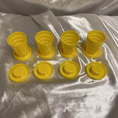 4 VINTAGE PLASTIC COLLAPSIBLE TRAVEL CUP AND PILL BOX TUCKAWAY  Yellow • $2.81