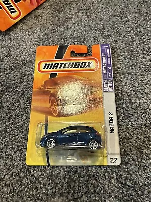 Matchbox Mazda 2 1/64 Diecast Mint On Card METALFLAKE BLUE VARIATION (2009) • $19.89