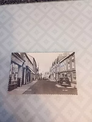 Postcard West Street Rhayader Radnorshire Wales. Shops And Old Vintage Cars • £0.99