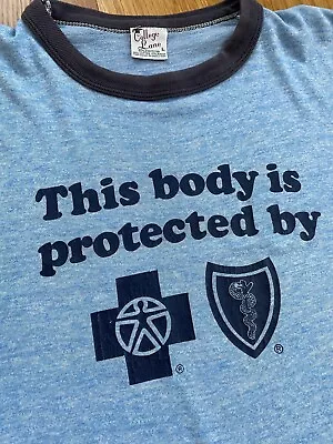 Vintage This Body Is Protected By Blue Cross Blue Shield Ringer T Shirt Size L • $24