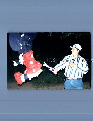 Found Color Photo K+3010 Man In Hat Swinging At Minnie Mouse Pinata • $3.98