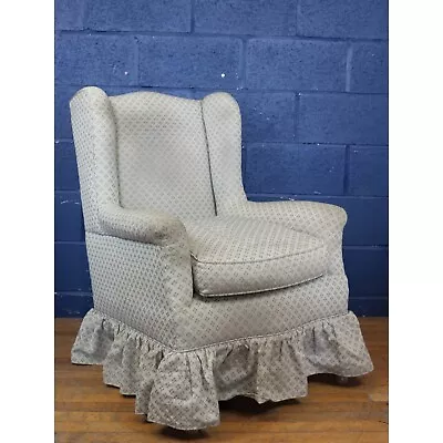 A Large Edwardian Upholstered Wing Arm Chair Raised On Tapering Supports • £150