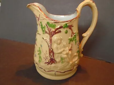 YELLOW WARE MOLDED PITCHER BOY WITH BIRDS NEST C. 1850'S • $65