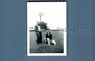 Found B&w Photo N_2179 Man Posed By Woman Crouching By Dog • $6.98