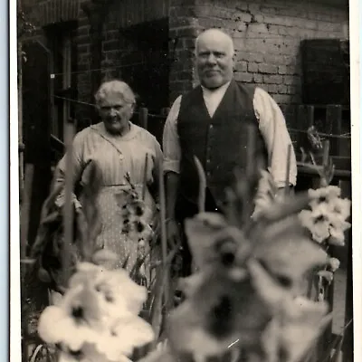 C1910s Old Couple RPPC Brick House Real Photo Unique Flower Photography PC A185 • $11.25