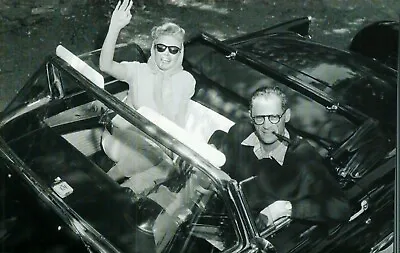 * Postcard- Happy Couple In Convertible...Lady W/Sunglasses Waves   (U2-02) • $4.99