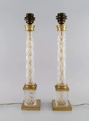 A Pair Of Tall And Sleek Table Lamps In Clear Crystal Glass And Brass. • $1000