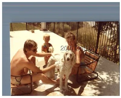 Found Color Photo F_6854 Man And Woman In Swimsuits Sitting By Dog • $4.98