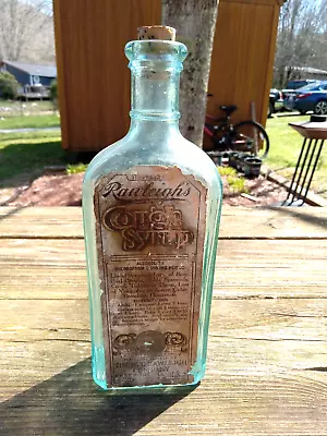 Antique RAWLEIGH'S COUGH SYRUP 8.5  Aqua Glass Medicine Bottle Paper Label EMPTY • $40