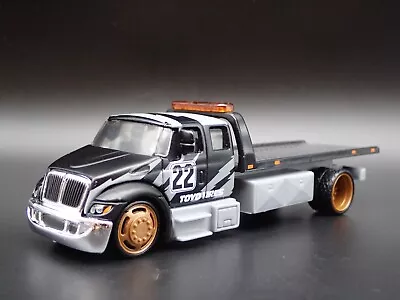 International Durastar Flatbed Tow Truck Toyo Tires 1/64 Scale Diecast Model Car • $19.98