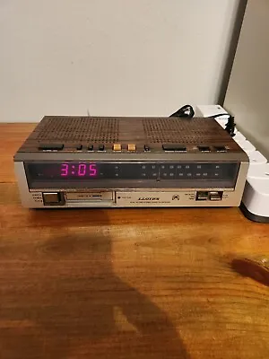 Vintage LLoyd's Am Fm Stereo Radio Alarm Clock Simulated Wood Grain Model J257B • $11.70