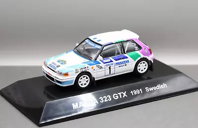 Cm's 1/64 Rally Car Collection SS.15 Mazda 323 Familia GTX 1991 No.1 Swedish WRC • $22