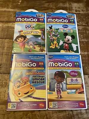 Mobigo Games Lot Of 4 Mickey Mouse Dora Twins Day Team Umizoomi Doc Mcstuffin • $24.99