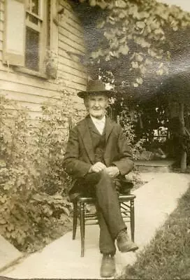 X464 Vtg Photo MAN IN HAT & SUIT SITTING IN LADDER BACK CHAIR SIDEWALK C 1900's • $4.50