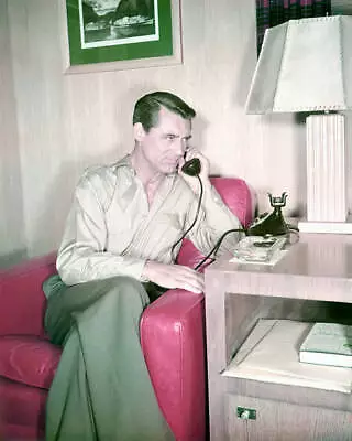 Cary Grant Sitting On A Red Sofa As He Holds A Telephone Receiver- Old Photo • $9