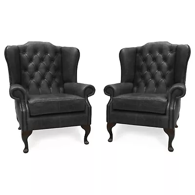 A Pair Of Chesterfield High Back Wing Chairs Presented  In Vintage Black Leather • £1385