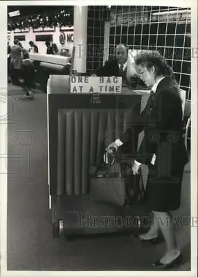 1989 Press Photo Erin Prince Places Bag On X-ray Security Machine-Mitchell Field • $15.99