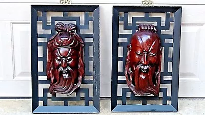 PAIR EARLY 20c CHINESE ROSEWOOD CARVED IMMORTAL MASKS ATTACHED TO METAL FRAME • $303.49