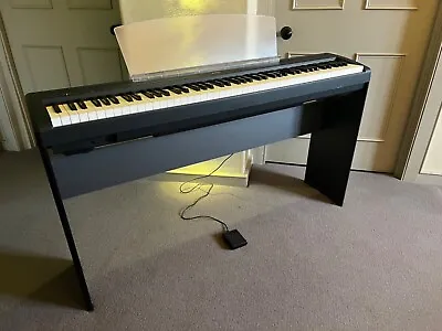 A Yamaha P-85 Digital Piano. • £275