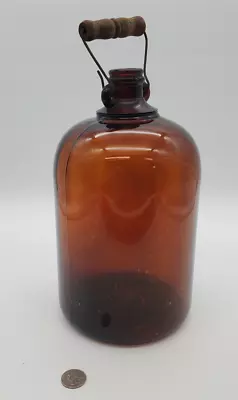 Unique VINTAGE AMBER LARGE GLASS JAR BOTTLE WITH METAL/WOODEN HANDLE • $16.95