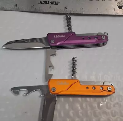 2 X Cabelas Pocket Knifes Orange And Purple • $12.99