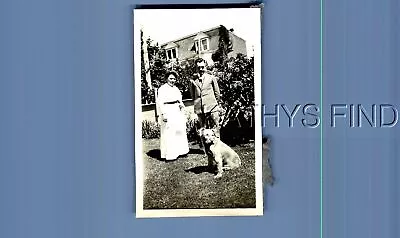 Found Vintage Photo G+8349 Man And Woman Posed In Yard By Dog Sitting • $6.98