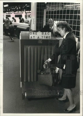 $19.99 • Buy 1989 Press Photo Erin Prince Places Bag On X-ray Security Machine-Mitchell Field