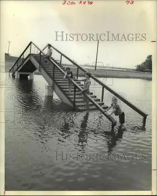 1974 Press Photo Boys Climb Bridge Inundated By Flood Water In Channelview Texas • $16.99