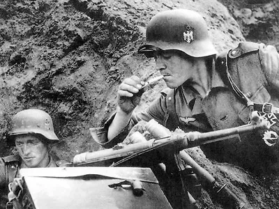 WWII B&W Photo  German Soldier Lights Cigarette MP40 Schmeisser  WW2 / 2330 • $5.99