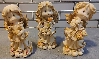7  Angel Figurines Holding Rose Puppy Flowers  - Set Of 3 • $13.50