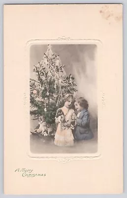 Postcard Christmas Boy & Girl Under Christmas Tree With Dolls & Toys Embossed • $13.50