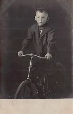 YOUNG BOY-MILITARY? LOGO ON TIE-SITTING ON BICYCLE~1910s REAL PHOTO POSTCARD • $9.73